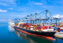 Container ship docked at a busy industrial port