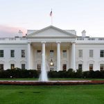 The White House with fountain and American flag