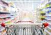 Shopping cart in aisle of grocery store