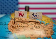 Republican and Democratic flags on USA map background.