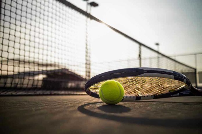 545014621 Tennis racket and ball on court near net