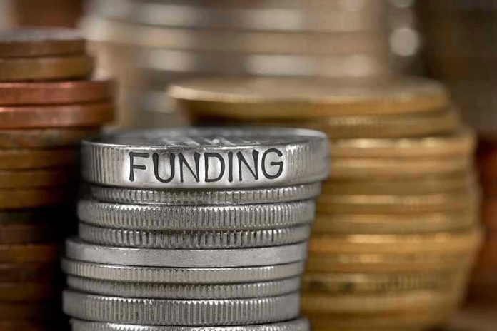 784896787 Stack of coins labeled funding with other coins stacks