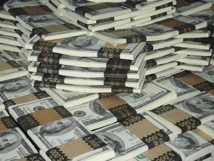 shutterstock_3315452.jpg Piles of bundled cash stacked together