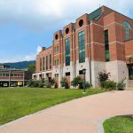 Modern educational building on a college campus with landscaped grounds