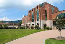 Modern educational building on a college campus with landscaped grounds