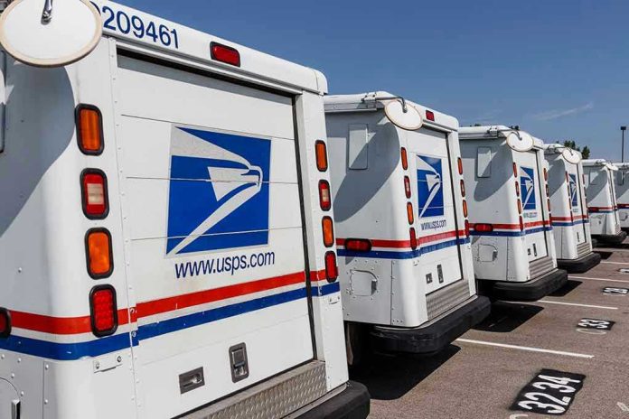 1475396903 Row of USPS mail trucks parked in lot.