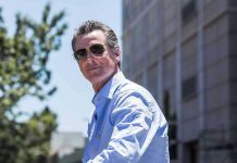 Man in sunglasses wearing a blue button up shirt