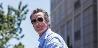 Man in sunglasses wearing a blue button up shirt