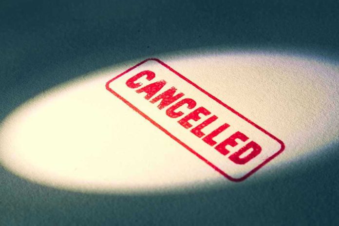 Red Cancelled stamp under a spotlight.