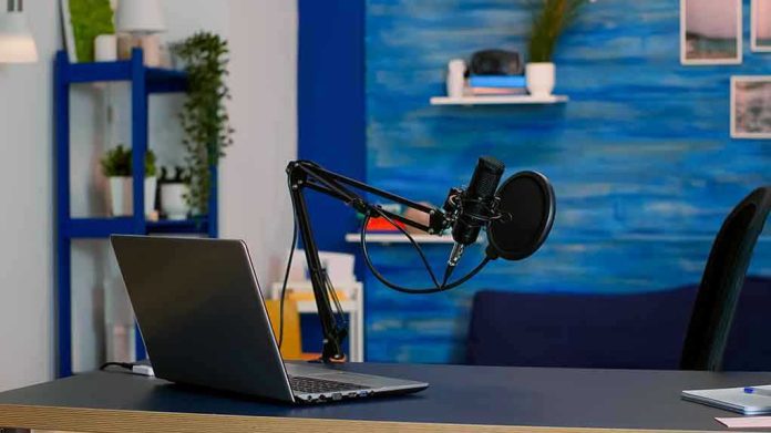 1939096570 Laptop and a microphone on a desk