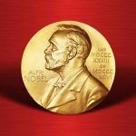 Gold Nobel Prize medal on red background