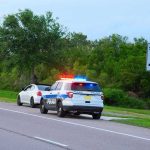 Police car pulling over a white car