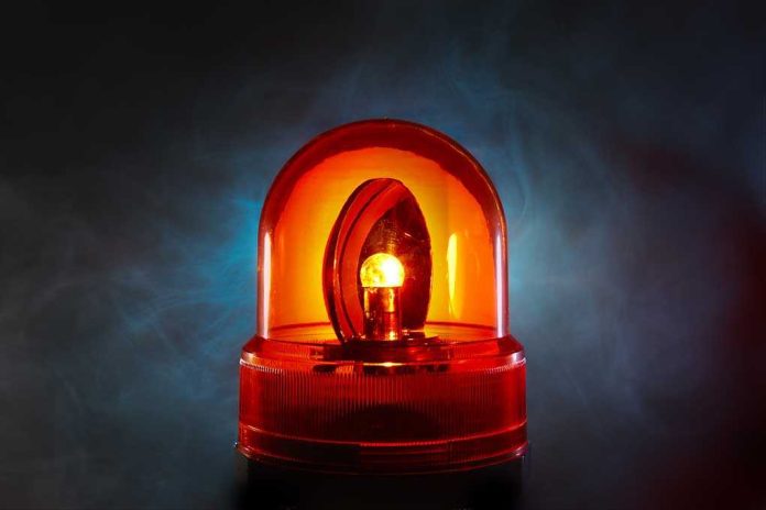 An illuminated orange emergency light on a dark background