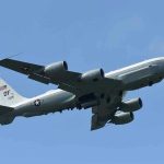 Shocking Stowaway Find: Major Security Concerns Unveiled Military aircraft flying in clear blue sky.