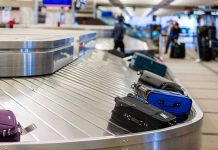 Luggage on airport baggage claim conveyor belt.