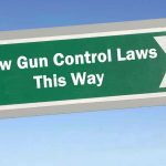 Alleged Anti-Gun Remarks Shake Michigan Race Sign: New Gun Control Laws This Way with arrow.