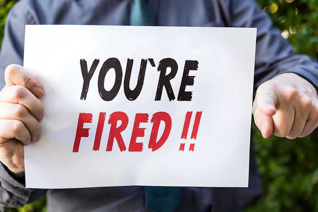 388134190 Person holding YOURE FIRED sign.