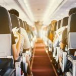 Midflight Meltdown Sparks Unusual Restraint System Passengers seated inside an airplane cabin.