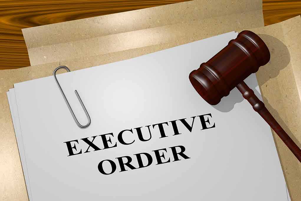 A gavel resting on a document labeled 'EXECUTIVE ORDER'