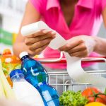 Midweek Madness: Catch Secret Grocery Markdowns Person examining a receipt while shopping for groceries