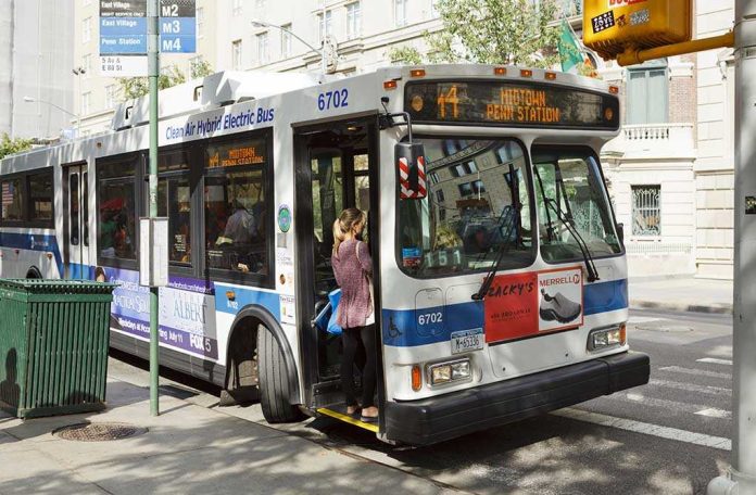 shutterstock_322498121.jpg A woman boarding a clean air hybrid electric bus at a city stop