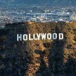 SHOCKING Layoff Wave Hits HOLLYWOOD – 2,000 Affected! The Hollywood sign on a hillside.