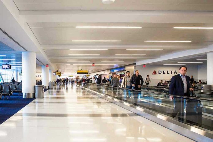 1089085346 People walking through a busy airport terminal.