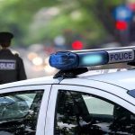 Parents BUSTED After Backyard Grave Discovery Police car and officer on a city street.