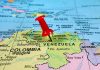 Trump’s War Drums—Venezuela Faces Unthinkable Pressure Red pin on Venezuela, South America map.