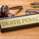 Death Penalty DEMAND—Ex-Prime Minister Vanishes Gavel, handcuffs, and Death Penalty sign on desk.