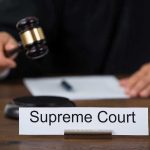 Supreme Court’s BOMBSHELL — Pivotal Case Happening NOW Judge with gavel and Supreme Court nameplate.