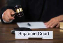 Supreme Court’s BOMBSHELL — Pivotal Case Happening NOW Judge with gavel and Supreme Court nameplate.