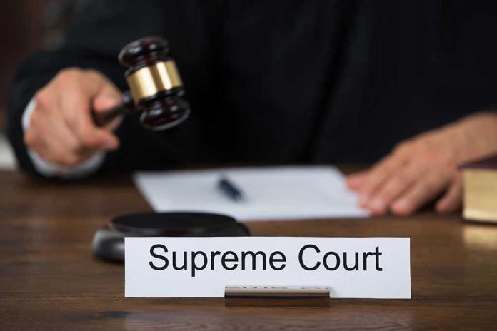 359957222 Judge with gavel and Supreme Court nameplate.