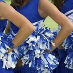 Cheer Gym Horror: Victims as Young as 8 Cheerleaders in blue and white uniforms holding pom poms