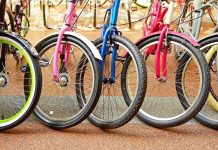 A row of colorful bicycles parked, showcasing their wheels and frames
