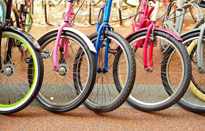 A row of colorful bicycles parked, showcasing their wheels and frames