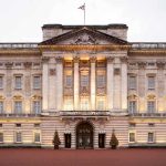 REVEALED — Shocking Royal Lease PROTECTS Prince Andrew Front view of Buckingham Palace with illuminated facade and British flag