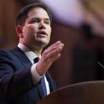 Rubio GUTS Extravagance—$100 Million Gone Overnight A man in a suit delivering a speech at a podium