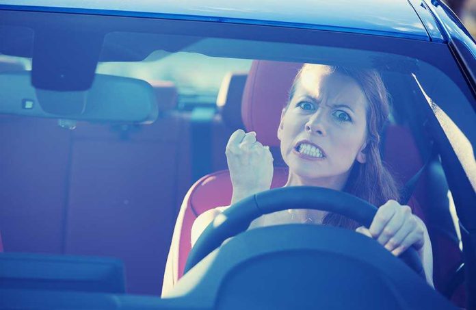 Angry woman gripping the steering wheel in a car