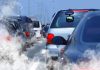 Highway Horror — 46 Dead in Collision Traffic jam with cars emitting exhaust fumes on a city road