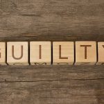 MS-13 Killers CONVICTED — Hot Tub HORROR Wooden blocks arranged to spell 'GUILTY' on a wooden surface