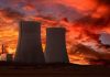 Chernobyl Dogs Turn ELECTRIC BLUE Overnight Silhouette of cooling towers against a vibrant sunset sky