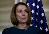 Pelosi Tracker Ignites Wall Street Frenzy Person standing near American flag indoors