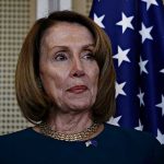 Pelosi Tracker Ignites Wall Street Frenzy Person standing near American flag indoors