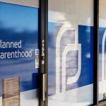 Planned Parenthood Shooter DIES in Custody Planned Parenthood office entrance with logo and signs.