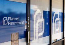 Planned Parenthood Shooter DIES in Custody Planned Parenthood office entrance with logo and signs.