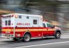 ICE Agent SERIOUSLY INJURED in Houston Horror Red and white ambulance driving on street.
