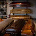 Chilling Murder Exposes Funeral Home Deceit Showroom with coffins and urns.