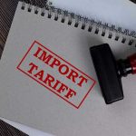 Massive Tariff DEFEAT Looms For Trump? Notebook with Import Tariff stamp and rubber stamper.