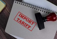Massive Tariff DEFEAT Looms For Trump? Notebook with Import Tariff stamp and rubber stamper.